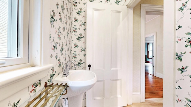 93 Fessenden St, Portland, ME 04103 - bathroom featuring wallpapered walls and wood finished floors