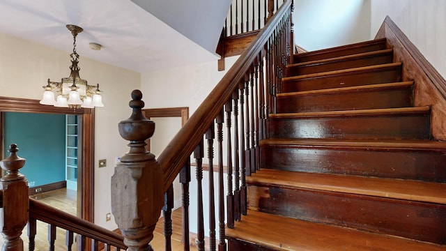 93 Fessenden St, Portland, ME 04103 - staircase featuring a chandelier and wood finished floors