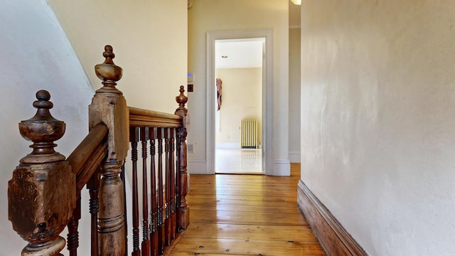 93 Fessenden St, Portland, ME 04103 - hall featuring radiator heating unit, light wood-type flooring, and an upstairs landing