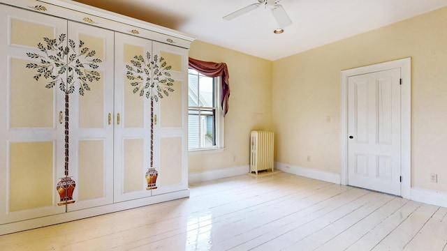 93 Fessenden St, Portland, ME 04103 - spare room featuring radiator, ceiling fan, and light wood-style flooring