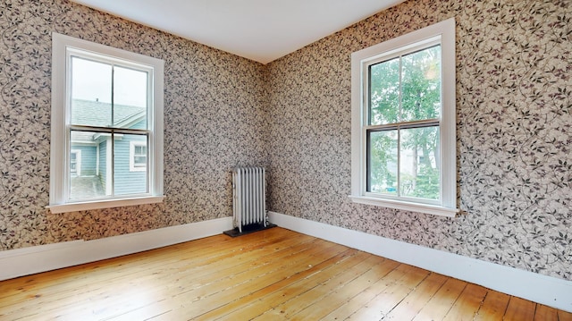 93 Fessenden St, Portland, ME 04103 - empty room with radiator, hardwood / wood-style flooring, and wallpapered walls