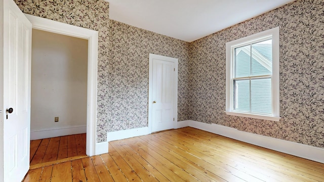 93 Fessenden St, Portland, ME 04103 - spare room with wood-type flooring and wallpapered walls
