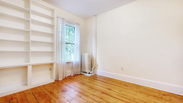 93 Fessenden St, Portland, ME 04103 - empty room with radiator heating unit and hardwood / wood-style flooring