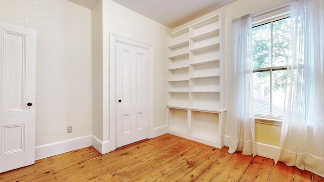 93 Fessenden St, Portland, ME 04103 - unfurnished bedroom with light wood-style floors and multiple windows