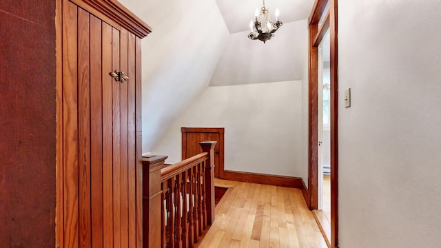 93 Fessenden St, Portland, ME 04103 - hall featuring an upstairs landing, vaulted ceiling, light wood-style floors, and a chandelier