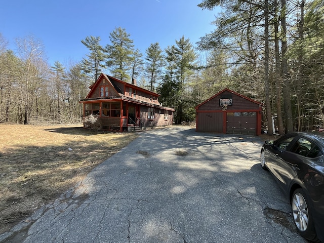 106 S Belfast Ave, Augusta, ME 04330 - view of side of property featuring asphalt driveway, an outdoor structure, and a garage
