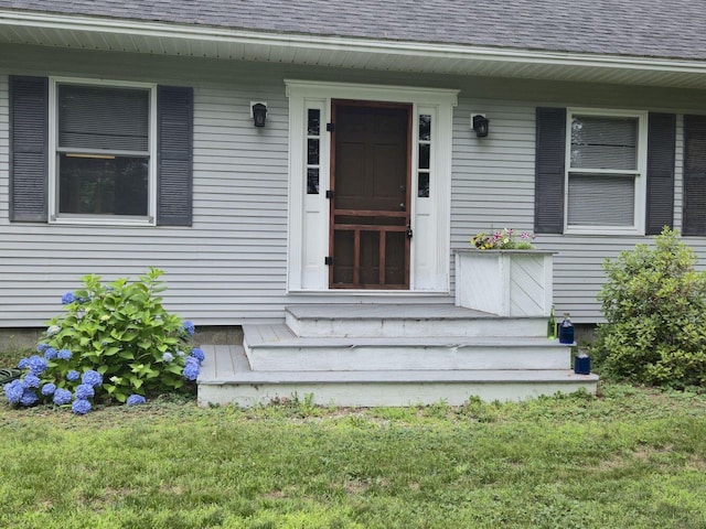 411 Augusta Rd, Belgrade, ME 04917 - property entrance featuring roof with shingles and a yard