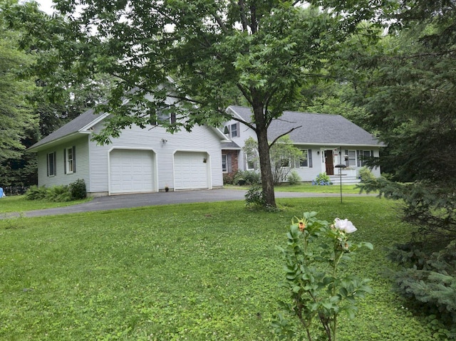 411 Augusta Rd, Belgrade, ME 04917 - view of front facade featuring asphalt driveway, a front yard, and a garage