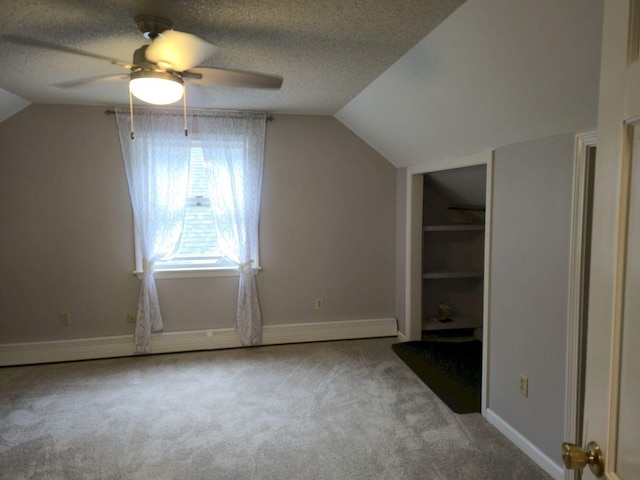 411 Augusta Rd, Belgrade, ME 04917 - additional living space featuring ceiling fan, lofted ceiling, carpet, and a textured ceiling