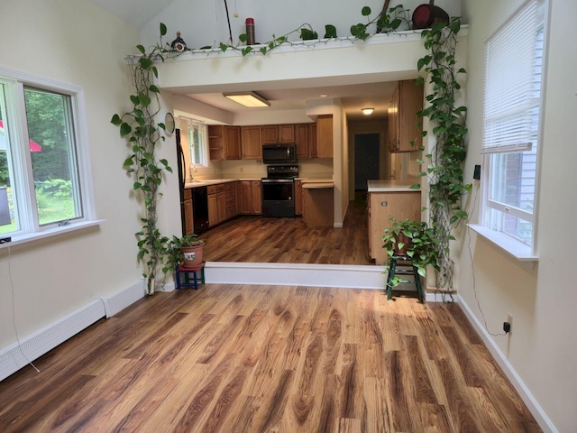 411 Augusta Rd, Belgrade, ME 04917 - kitchen featuring black appliances, light countertops, dark wood-style floors, brown cabinetry, and healthy amount of natural light