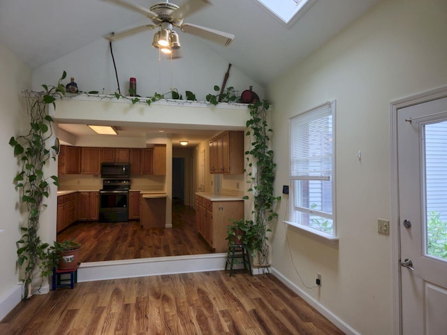 411 Augusta Rd, Belgrade, ME 04917 - kitchen featuring stainless steel electric stove, black microwave, brown cabinetry, high vaulted ceiling, and dark wood-type flooring