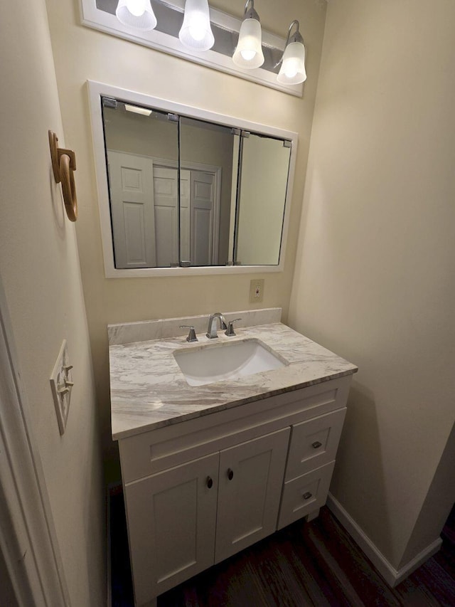 411 Augusta Rd, Belgrade, ME 04917 - bathroom with vanity and wood finished floors