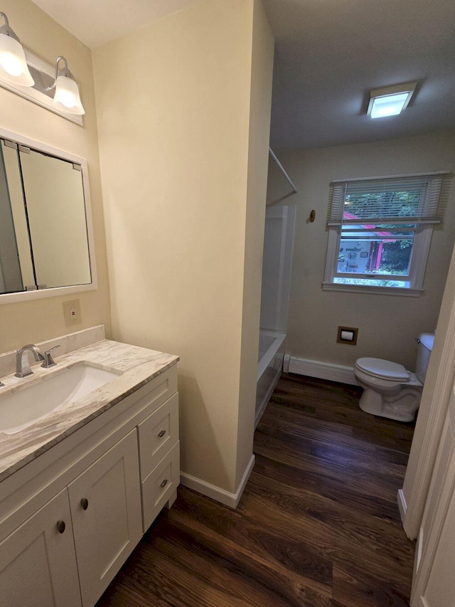411 Augusta Rd, Belgrade, ME 04917 - bathroom with vanity, wood finished floors, baseboard heating, and bathing tub / shower combination
