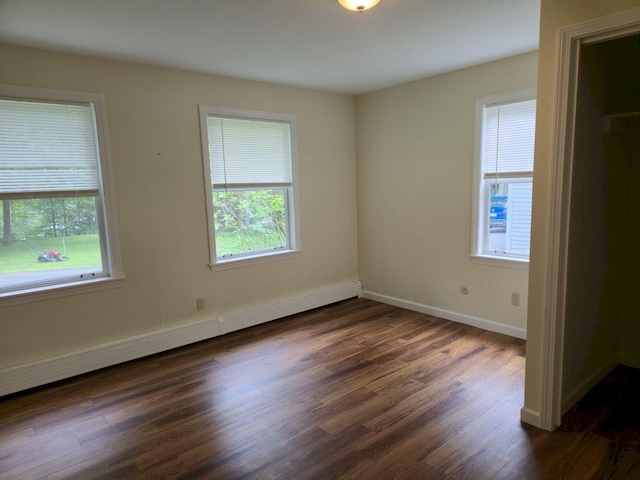 411 Augusta Rd, Belgrade, ME 04917 - empty room featuring baseboard heating and dark wood-style floors