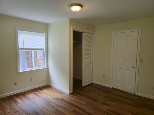 411 Augusta Rd, Belgrade, ME 04917 - unfurnished bedroom featuring dark wood-type flooring and a closet