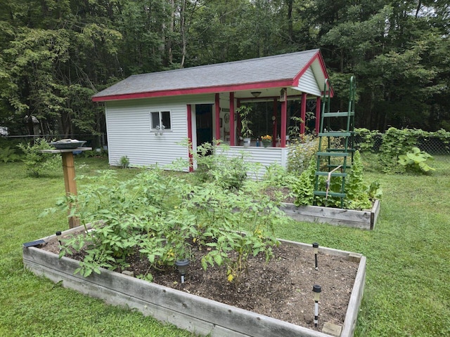 411 Augusta Rd, Belgrade, ME 04917 - view of outdoor structure with a vegetable garden and a wooded view