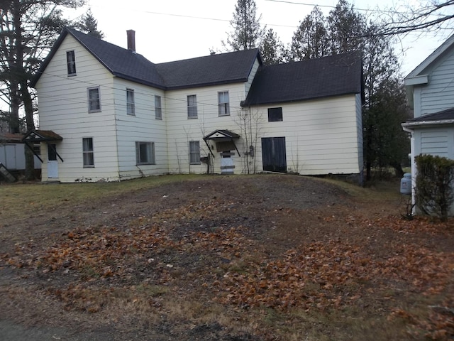7 Clark St, Calais, ME 04619 - rear view of house with roof with shingles and a chimney