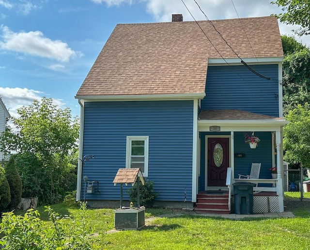 31 Blake St, Brewer, ME 04412 - view of front of property featuring a chimney, a shingled roof, a front yard, and covered porch