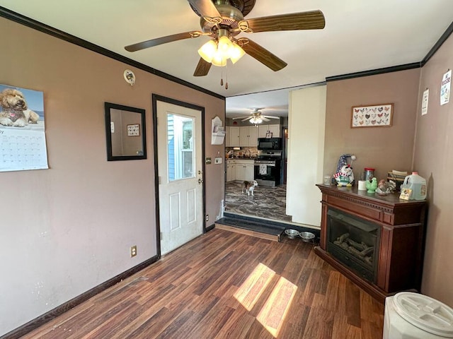 31 Blake St, Brewer, ME 04412 - living room with dark wood finished floors, ceiling fan, and ornamental molding