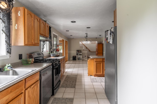 230 W Old Main Rd, Lowell, ME 04493 - kitchen with stainless steel appliances, under cabinet range hood, light tile patterned flooring, light countertops, and recessed lighting