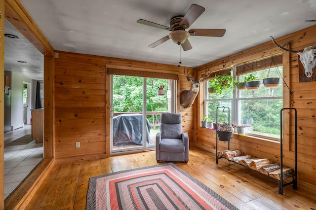 230 W Old Main Rd, Lowell, ME 04493 - sitting room featuring hardwood / wood-style flooring, wood walls, and ceiling fan