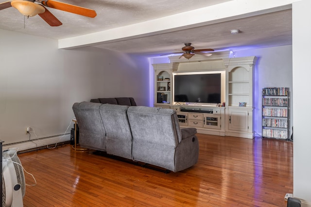 230 W Old Main Rd, Lowell, ME 04493 - living room featuring a ceiling fan, baseboard heating, hardwood / wood-style floors, and beamed ceiling