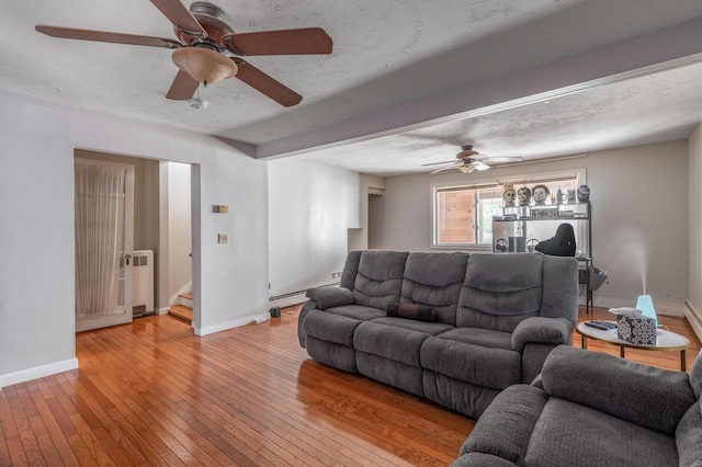 230 W Old Main Rd, Lowell, ME 04493 - living room with ceiling fan, light wood-type flooring, stairway, and radiator heating unit