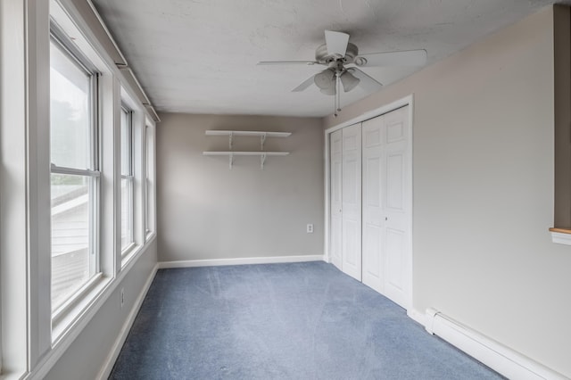 230 W Old Main Rd, Lowell, ME 04493 - unfurnished bedroom featuring a baseboard radiator, carpet floors, a closet, and ceiling fan