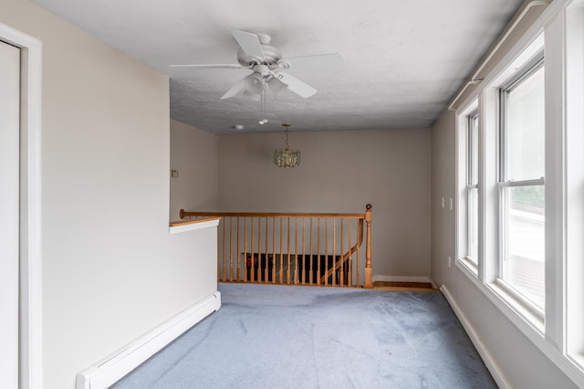 230 W Old Main Rd, Lowell, ME 04493 - carpeted empty room featuring a baseboard radiator and ceiling fan