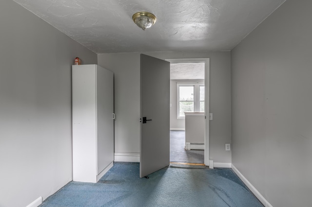 230 W Old Main Rd, Lowell, ME 04493 - unfurnished room with baseboard heating, carpet, and a textured ceiling