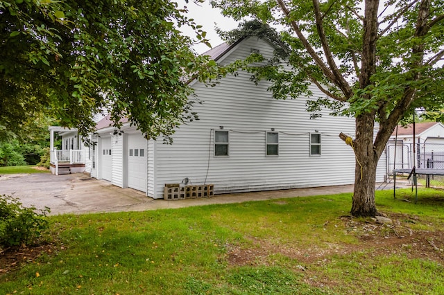 230 W Old Main Rd, Lowell, ME 04493 - view of home's exterior with a yard, driveway, and a trampoline