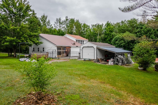 230 W Old Main Rd, Lowell, ME 04493 - rear view of house with an outbuilding, a garage, and a metal roof