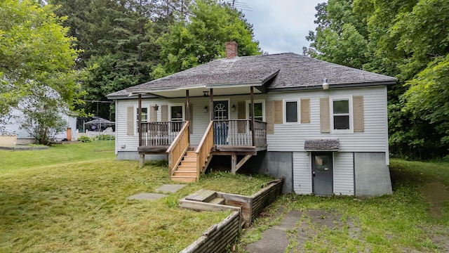 180 Lawrence St, Dover-Foxcroft, ME 04426 - view of front of home featuring a front yard, covered porch, and a chimney
