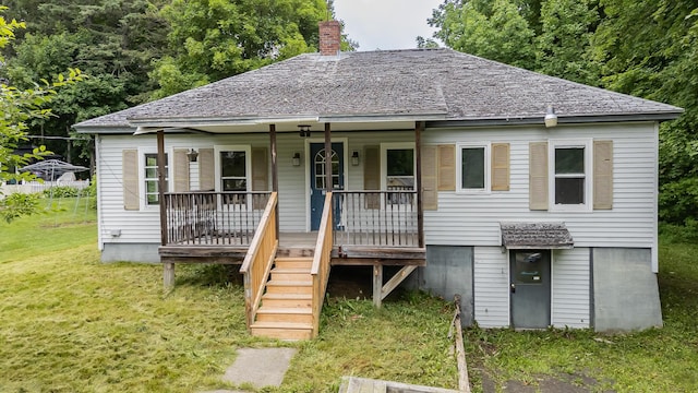 180 Lawrence St, Dover-Foxcroft, ME 04426 - bungalow featuring a front lawn, covered porch, a chimney, and stairs