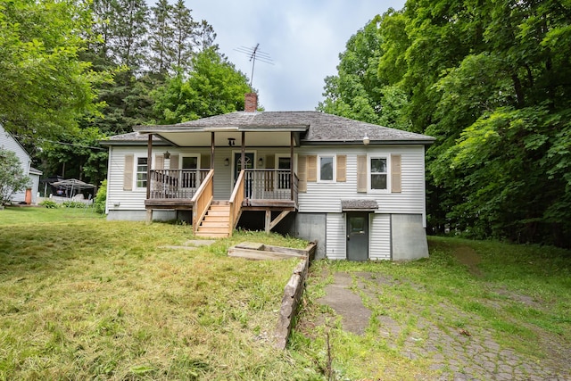 180 Lawrence St, Dover-Foxcroft, ME 04426 - back of house featuring a chimney, a yard, and covered porch
