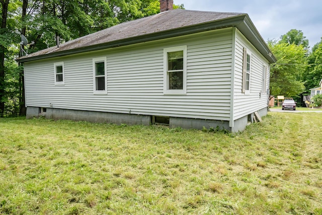 180 Lawrence St, Dover-Foxcroft, ME 04426 - view of side of property featuring a lawn and a chimney