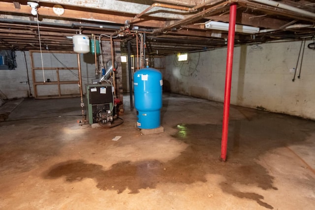 180 Lawrence St, Dover-Foxcroft, ME 04426 - unfinished below grade area with a water pressure tank and a heating unit