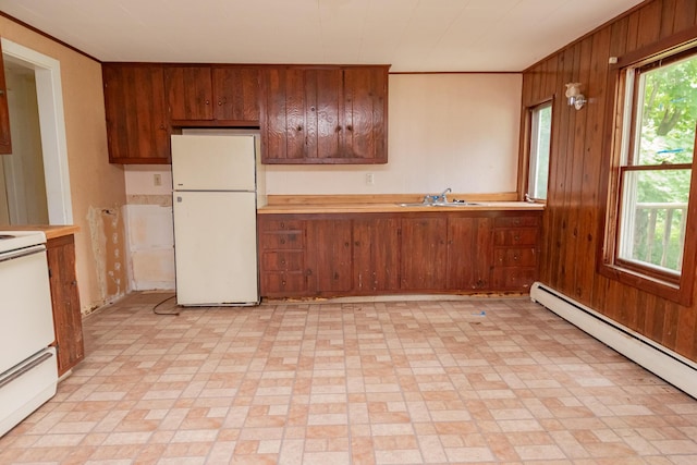 180 Lawrence St, Dover-Foxcroft, ME 04426 - kitchen featuring freestanding refrigerator, a baseboard radiator, wood walls, stove, and light countertops