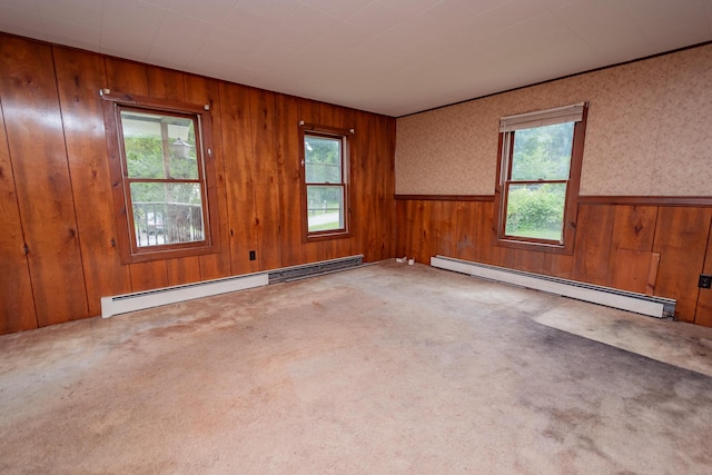180 Lawrence St, Dover-Foxcroft, ME 04426 - carpeted empty room featuring a baseboard radiator, wooden walls, and a wainscoted wall