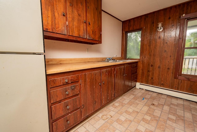 180 Lawrence St, Dover-Foxcroft, ME 04426 - kitchen with freestanding refrigerator, light countertops, and wooden walls