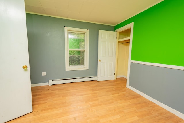180 Lawrence St, Dover-Foxcroft, ME 04426 - unfurnished bedroom with a baseboard heating unit, ornamental molding, and wood finished floors