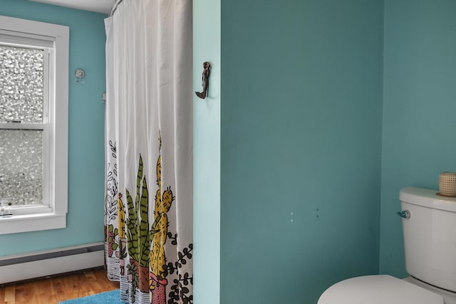 26 Wesley St Ct, Bath, ME 04530 - full bath with a baseboard radiator, wood finished floors, and a shower with shower curtain