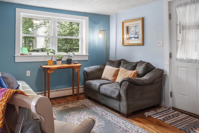 26 Wesley St Ct, Bath, ME 04530 - living area with a baseboard radiator, plenty of natural light, and wood finished floors