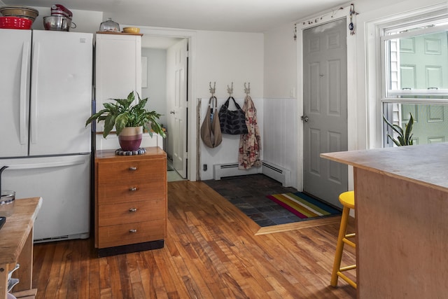 26 Wesley St Ct, Bath, ME 04530 - foyer featuring a baseboard heating unit, wood-type flooring, and a wainscoted wall
