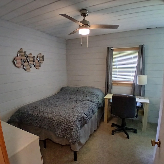393 Lagrange Rd, Bradford, ME 04410 - bedroom with wood walls, light carpet, and ceiling fan