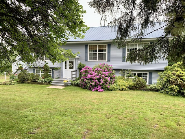 150 Leach Point Rd, Perry, ME 04667 - split foyer home featuring a front lawn and a metal roof