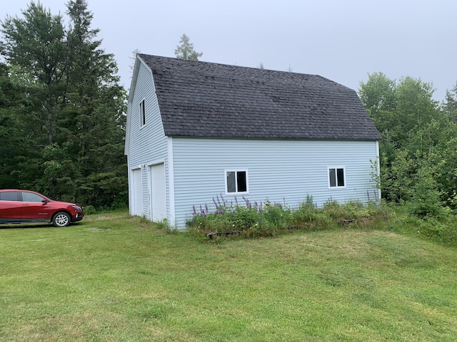 150 Leach Point Rd, Perry, ME 04667 - view of side of home with a gambrel roof, a shingled roof, and a yard