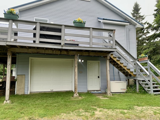 150 Leach Point Rd, Perry, ME 04667 - back of house with a garage, a wooden deck, stairway, and a yard