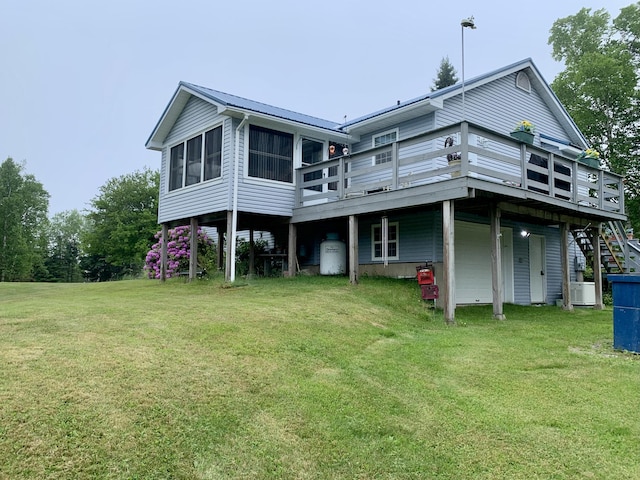 150 Leach Point Rd, Perry, ME 04667 - rear view of property with a deck, a lawn, a metal roof, and stairs
