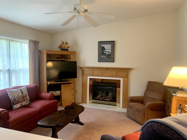 150 Leach Point Rd, Perry, ME 04667 - living room with light carpet, ceiling fan, and a fireplace with flush hearth